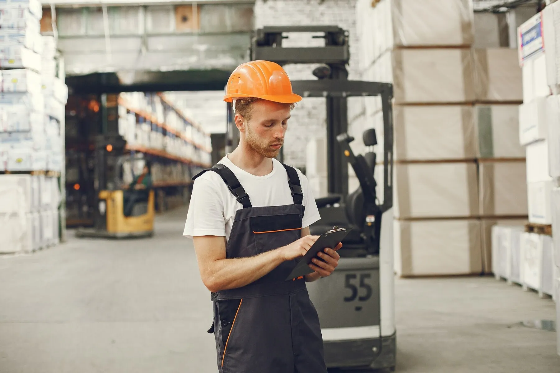 industrial-worker-indoors-factory-young-technician-with-orange-hard-hat_1157-40860